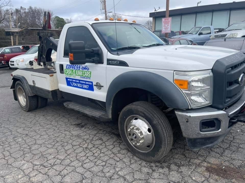 Express Cash For Junk Cars Charlotte branded tow truck with company signage on the door