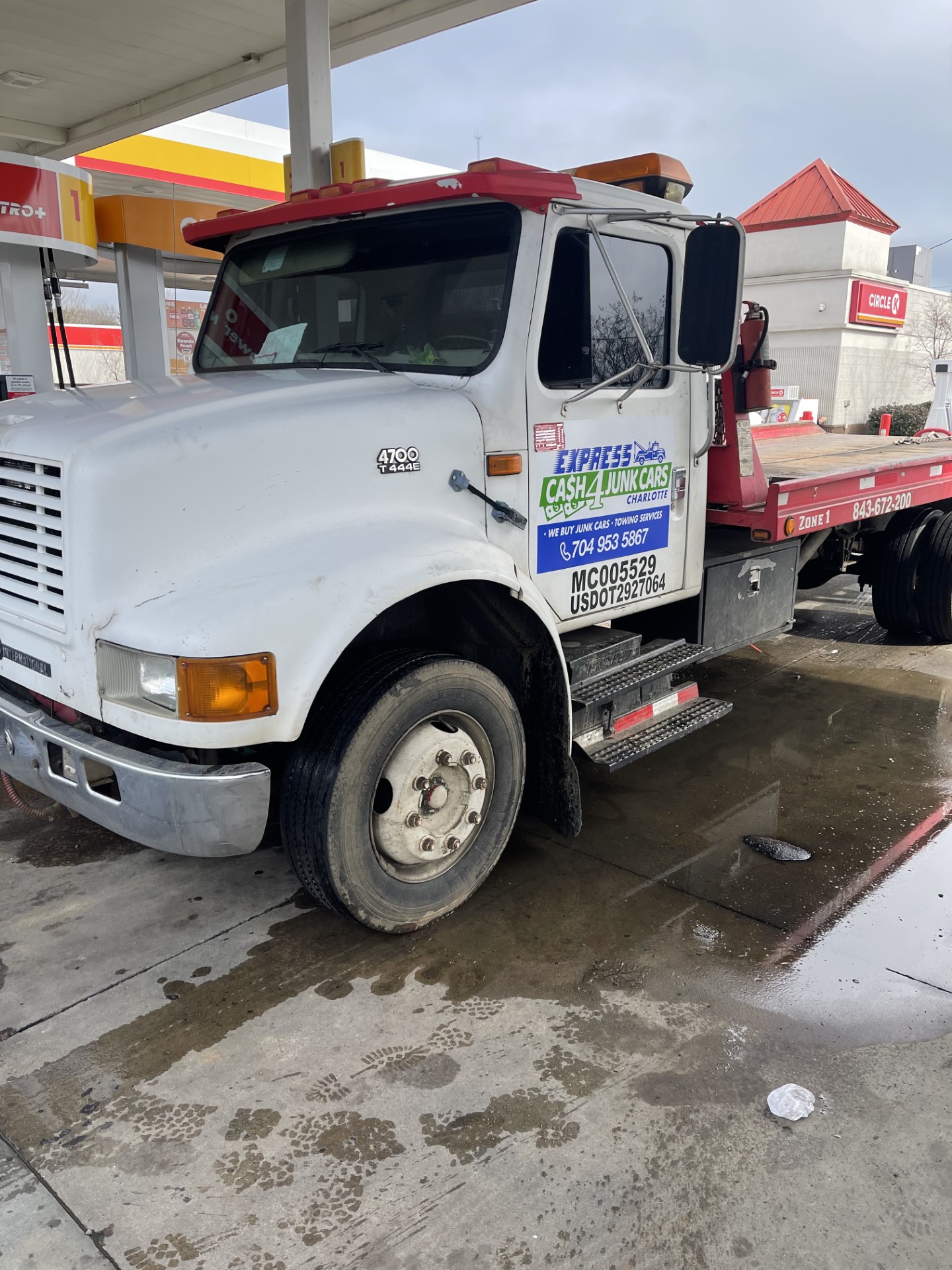 Express Cash For Junk Cars Charlotte rollback tow truck loading a vehicle